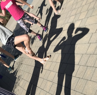 Kinder und ihre verschiedenen Tanzposen im Schattenwurf beim Outdoor-Training
